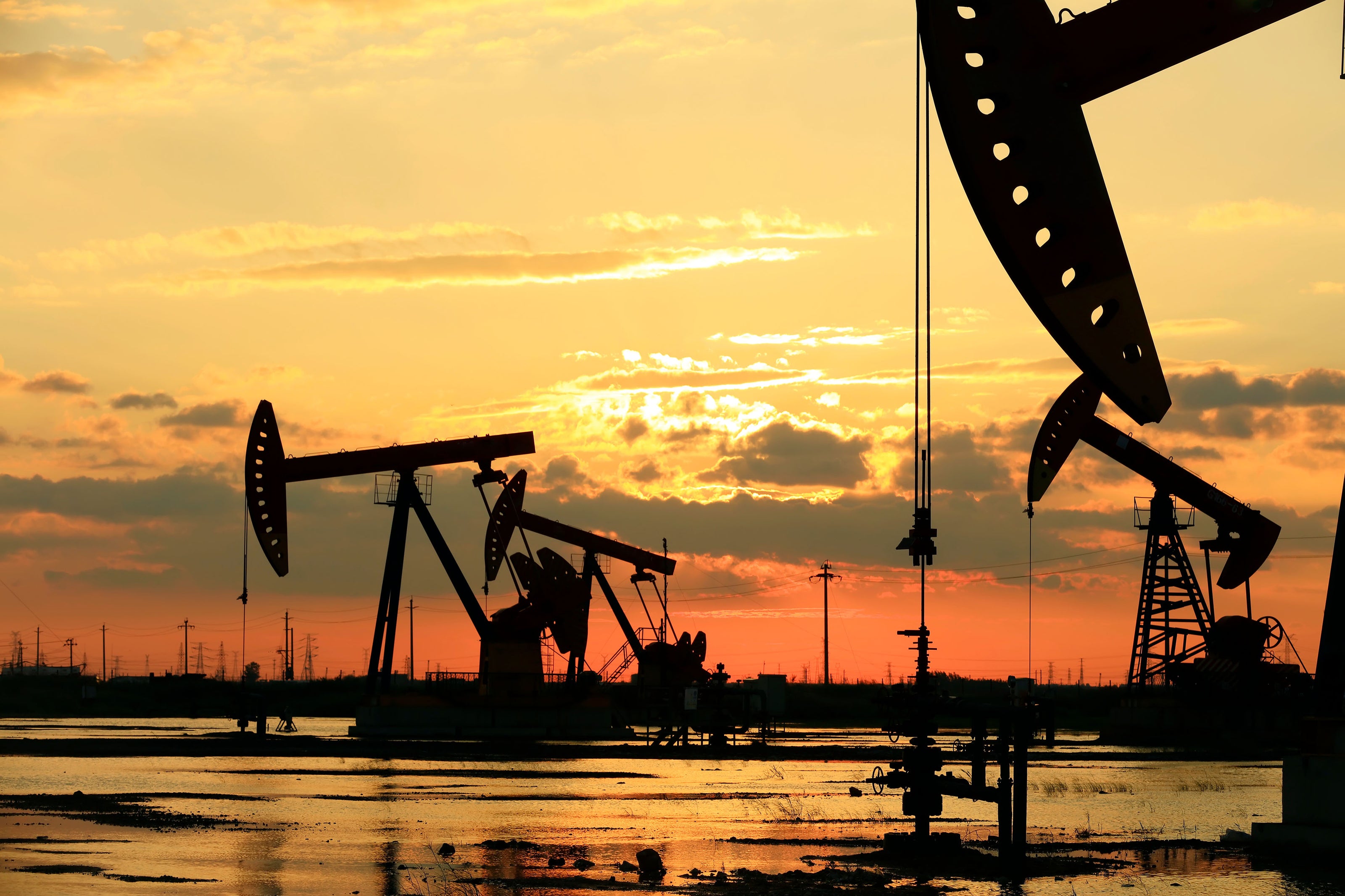 Oil field pump jacks at sunset